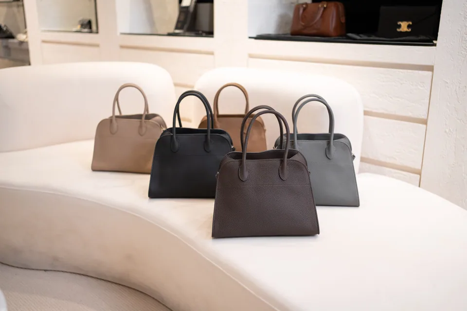 Neutral-toned leather handbags displayed in the Society in Fame showroom